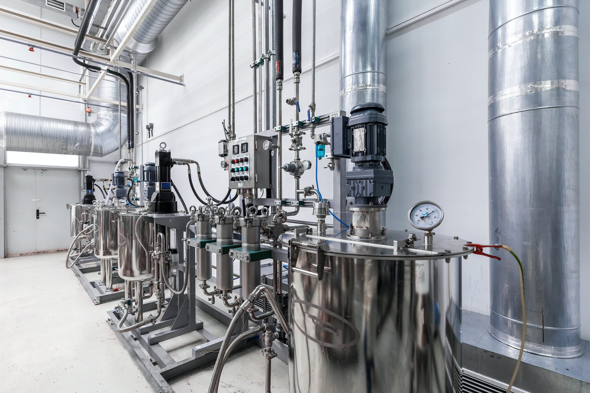 Photo of pipes and tanks. Chemistry and medicine production. Pharmaceutical plant. Interior of a
